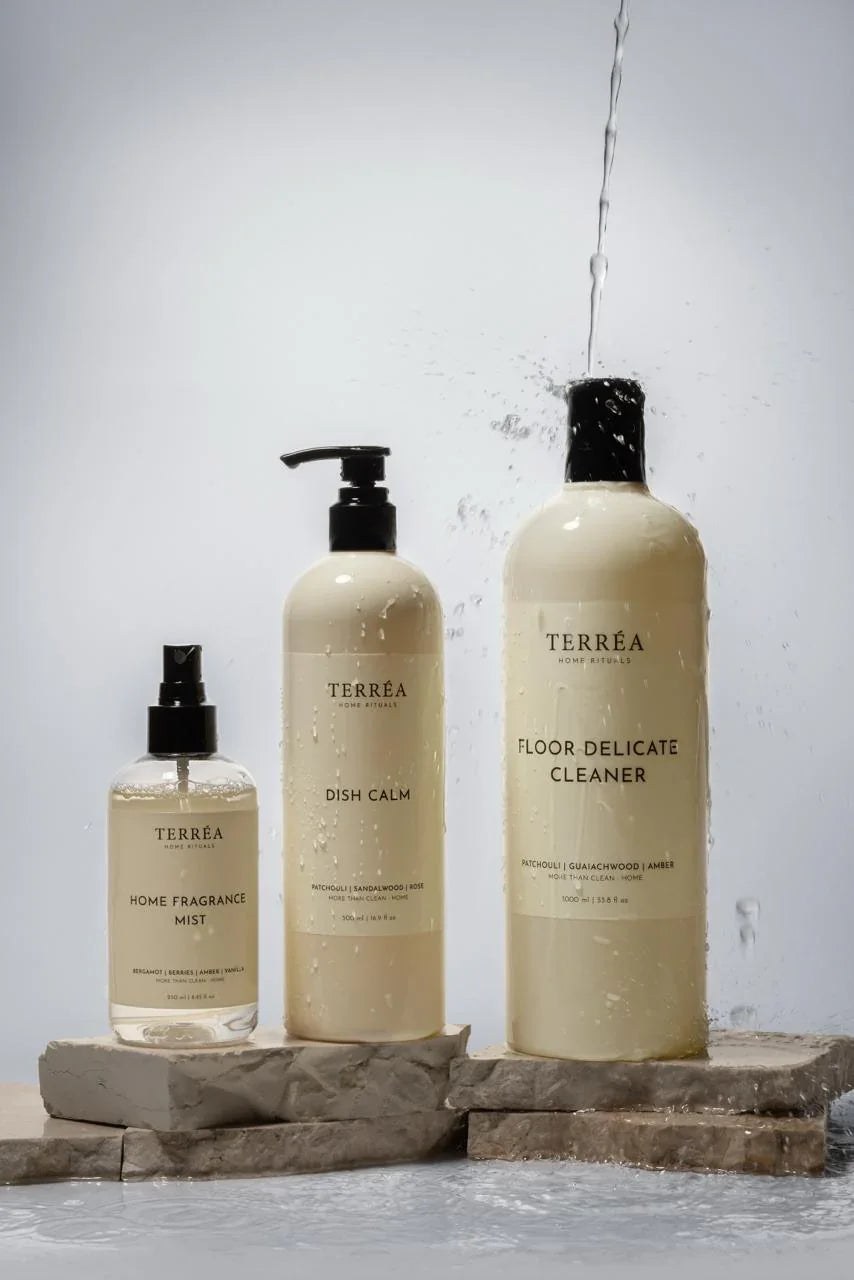 Eco-friendly home cleaning products: fragrance mist, dish soap, floor cleaner with water splash