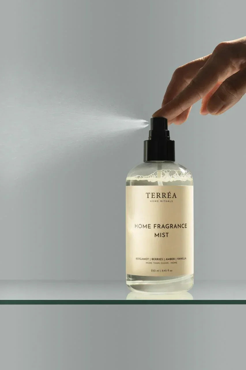 Hand spraying TERRÉA Home Fragrance Mist with bergamot, berries, amber, vanilla scent for sustainable luxury home care