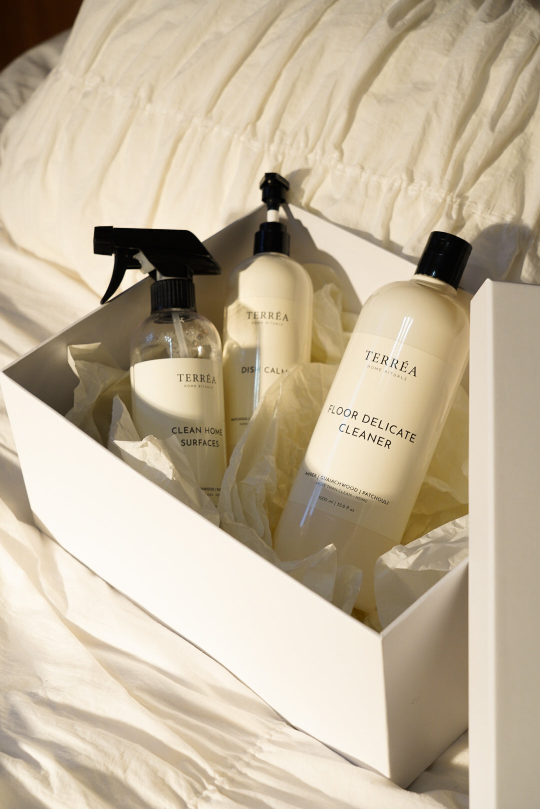 The Quiet House by Terréa in an open white gift box, a housewarming gift for a new kitchen