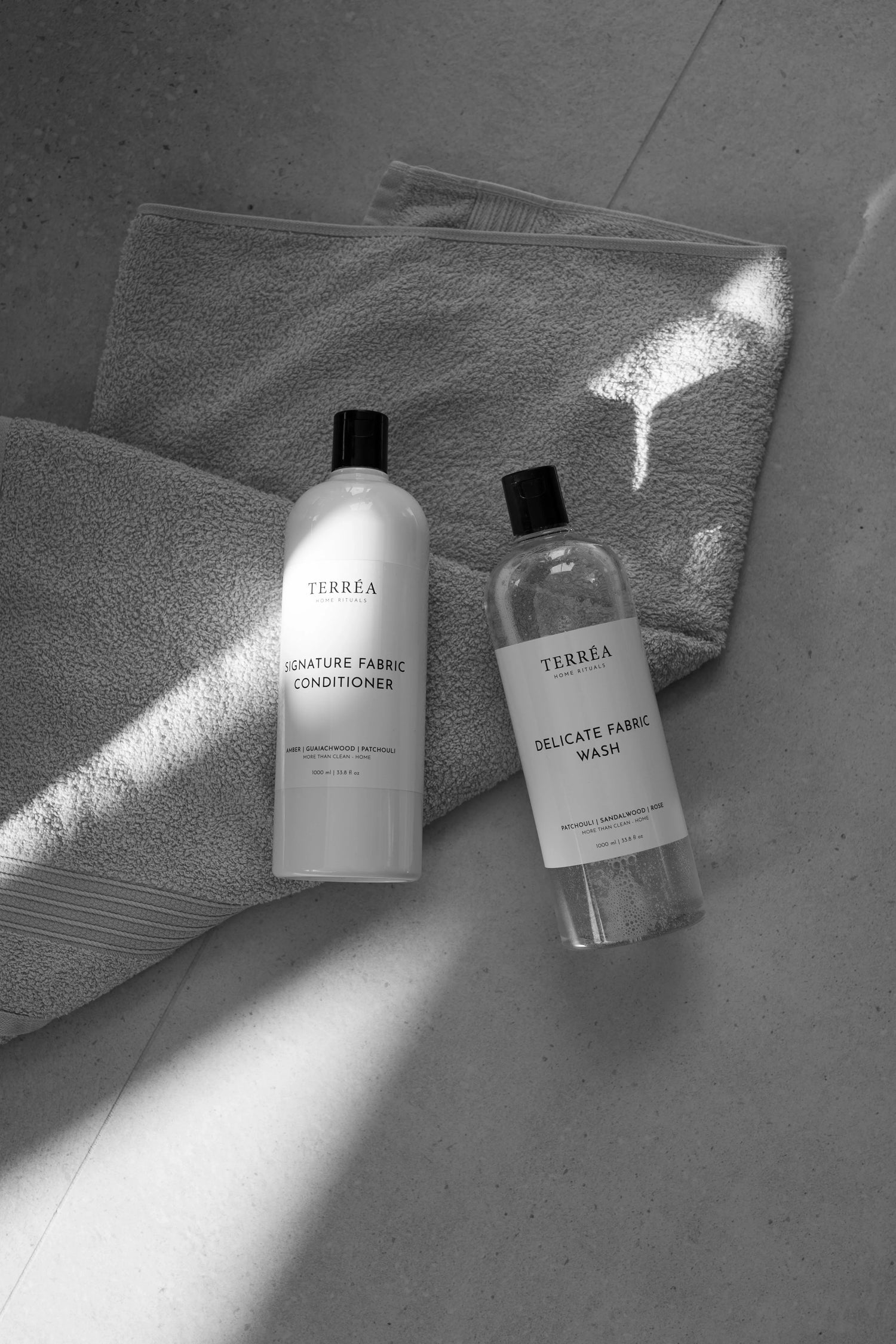 Terréa Delicate Fabric Wash and Signature Fabric Conditioner on folded towels in soft sunlight