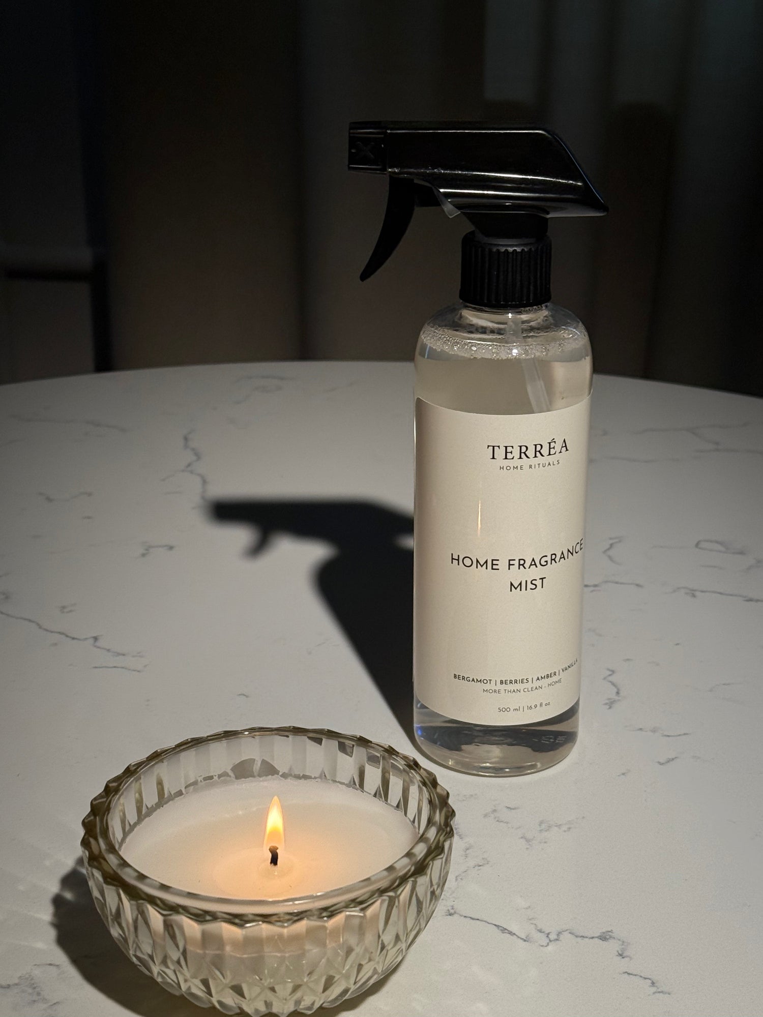 Terréa home fragrance and candle on a table in inviting light