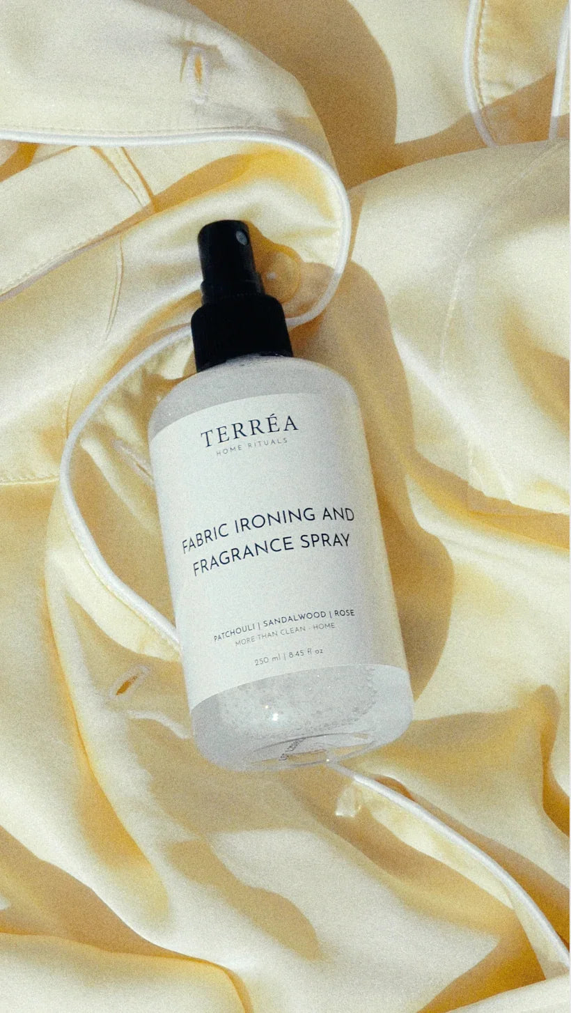 Bottle of Terréa fabric ironing and fragrance mist resting on satin.