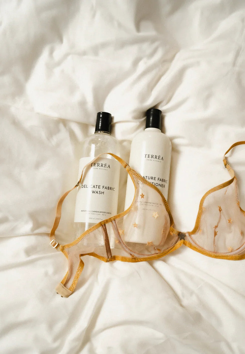 Fabric Conditioners and Fabric Softeners on the bed with bra