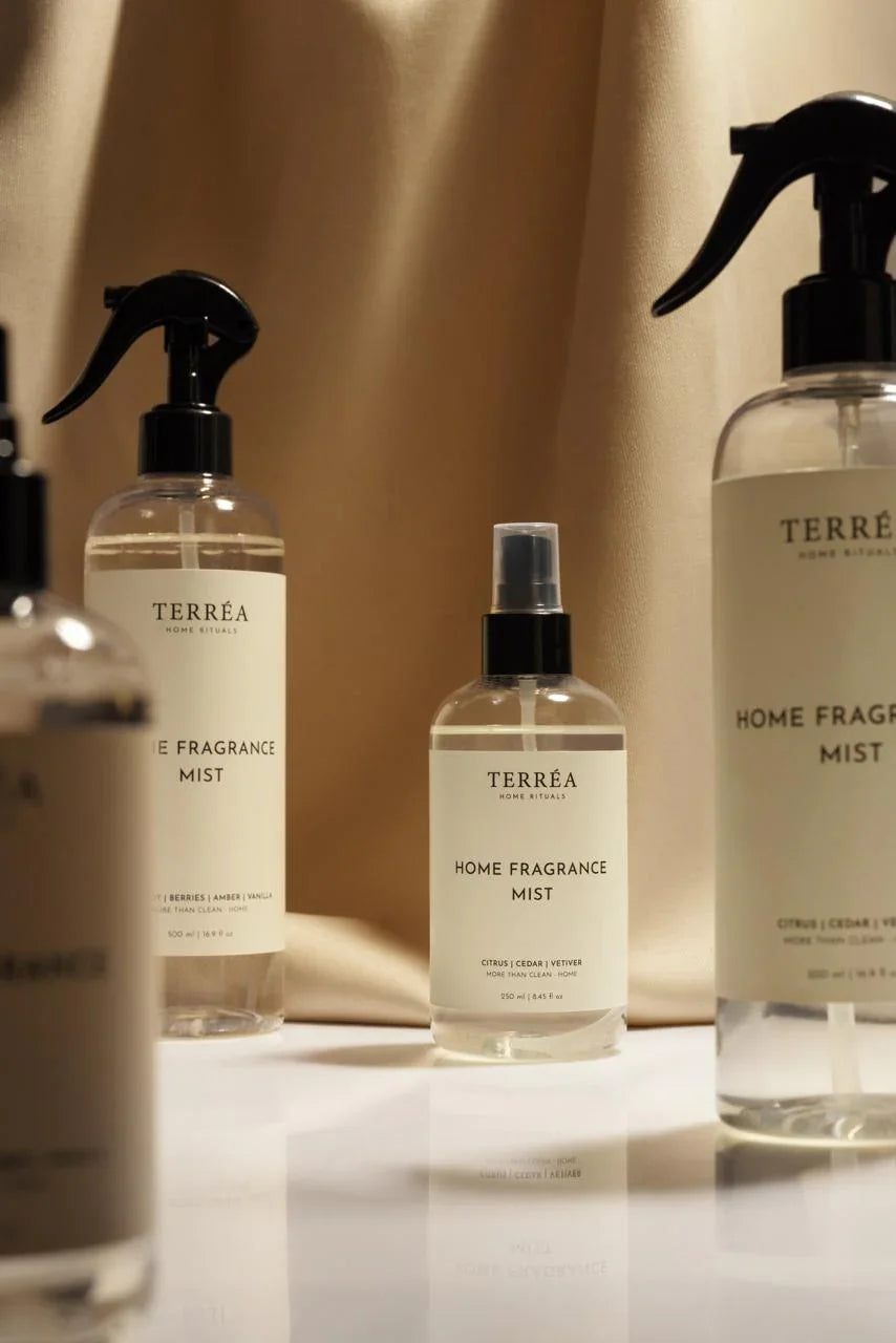 Terréa linen sprays arranged on a marble table; calm palette, minimal labels