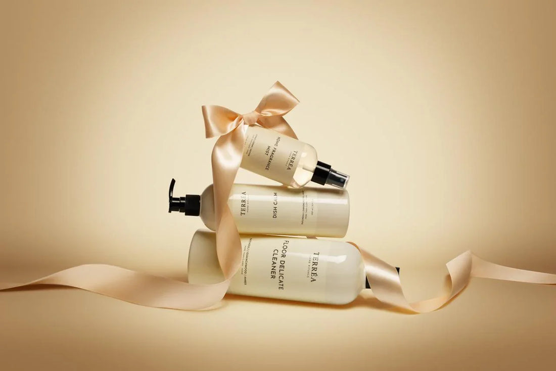 Three skincare bottles with ribbons on a beige background
