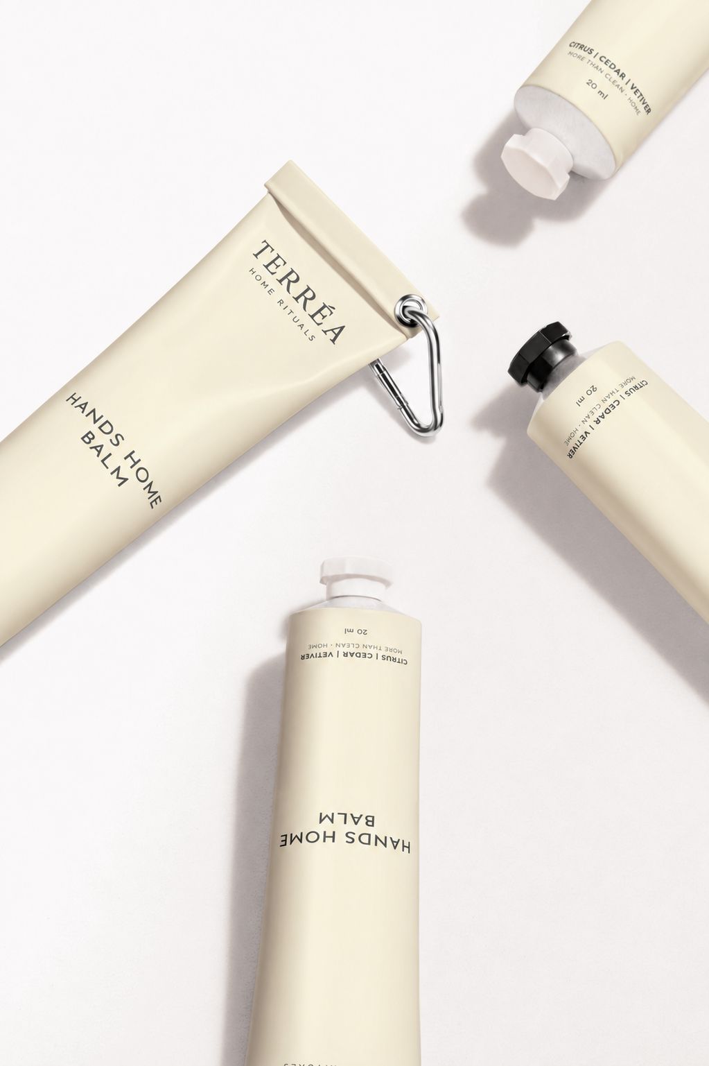 Terréa Hands Home Balm tubes arranged on a clean white surface with soft shadows and minimalist cream packaging.
