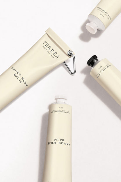 Terréa Hands Home Balm tubes arranged on a clean white surface with soft shadows and minimalist cream packaging.