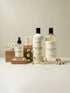 Terrea Home Rituals fabric care products with daisies, featuring conditioner, wash, and fragrance spray.