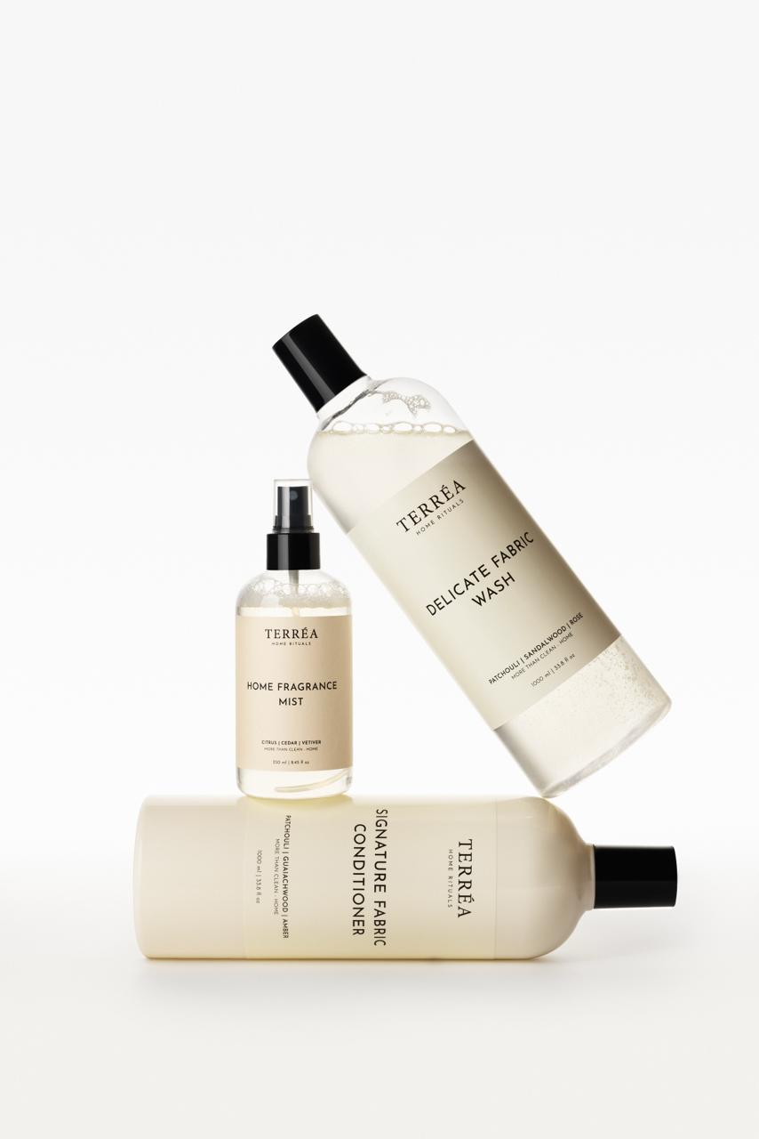 Set of Terrea skincare products including a bottle, mist, and conditioner on a white background