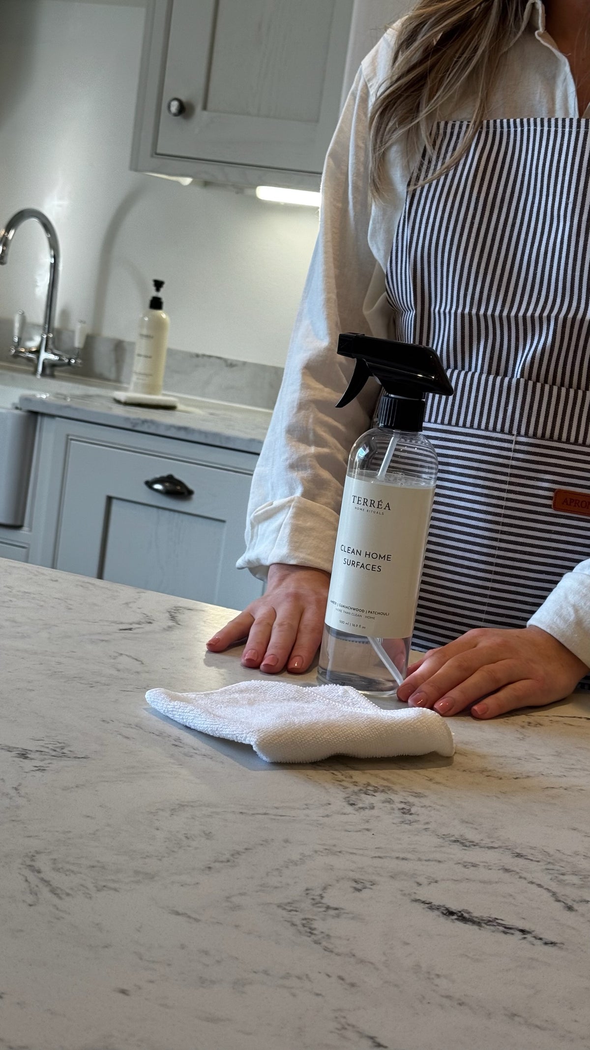 Eco-friendly home cleaning spray with cloth on marble countertop, sustainable luxury home care