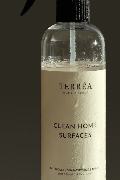 Bottle of Terrea Clean Home Surfaces cleaner with a dark background