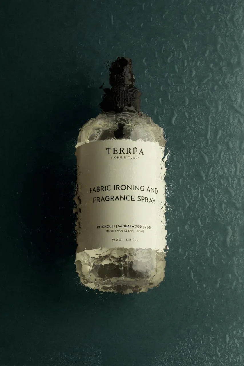Bottle of Terrea fabric ironing and fragrance spray against a dark background