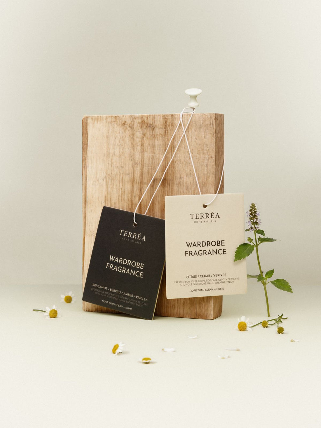 Terréa Wardrobe Fragrance cards Citrus / Cedar / Vetiver and Bergamot / Berries / Amber, hanging on a wooden board