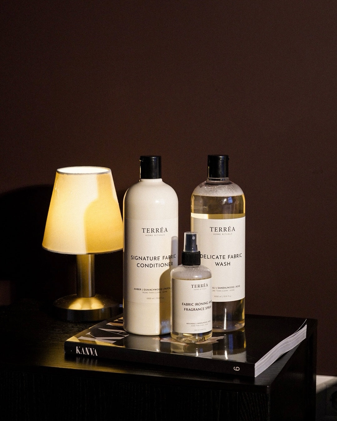 Terréa Delicate Fabric Wash, Signature Fabric Conditioner and Scented Ironing Water by a bedside lamp